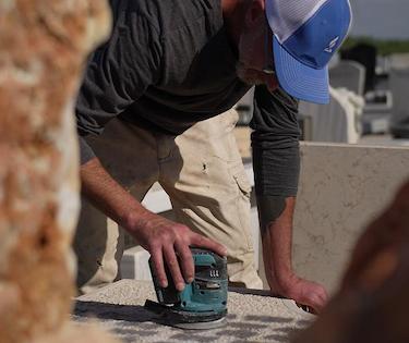 Professional Tending specialist carefully cleaning a headstone using safe, eco-friendly methods