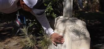 Careful care of a marble tombstone in a cemetery