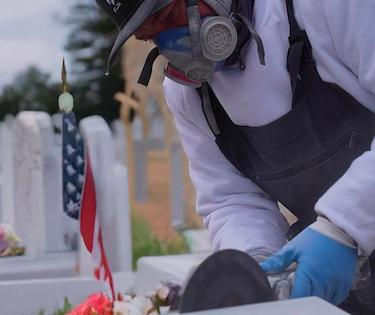 A Tending employee works in a protective mask
