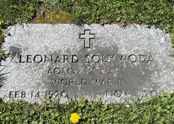 Weathered and uncleaned condition of granite flush grave marker in Connecticut before professional cleaning