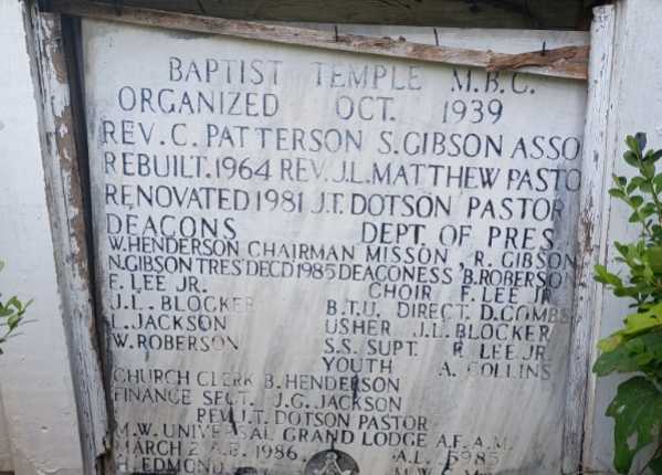 Weathered and uncleaned condition of flush bronze/black granite monument in Louisiana before professional cleaning