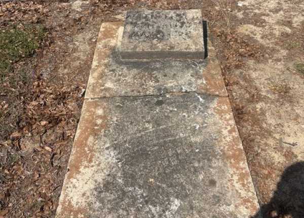 Weathered and uncleaned condition of granite bevel and concrete ledger markers in Georgia before professional cleaning