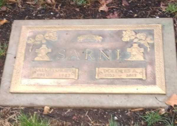 Weathered and uncleaned condition of metal flush grave marker in New Jersey before professional cleaning