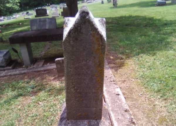 Weathered and uncleaned condition of granite headstone in Ohio before professional cleaning