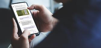 A man scrolls through the Tending app on his smartphone