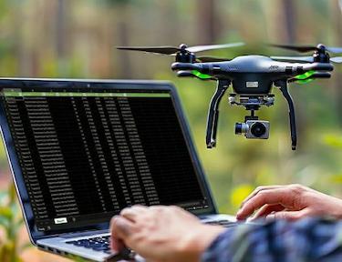 Tending specialist using GPS and drone technology to locate a grave site